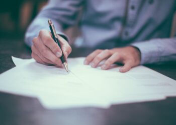 Official documents and paperwork on a desk representing government licensing