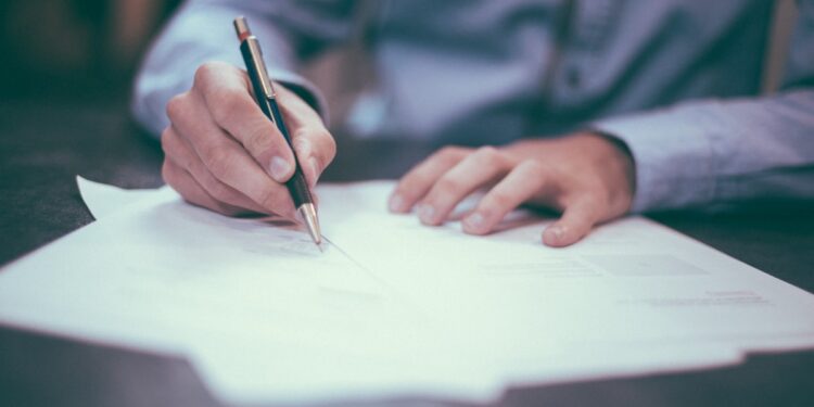 Official documents and paperwork on a desk representing government licensing